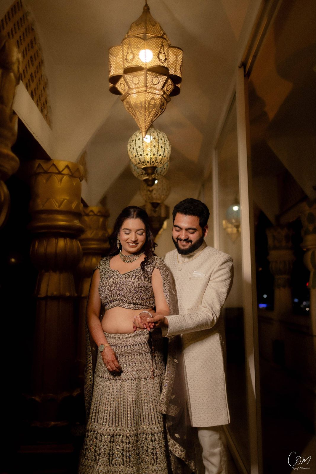 Satyam and Anshi beneath glowing lanterns