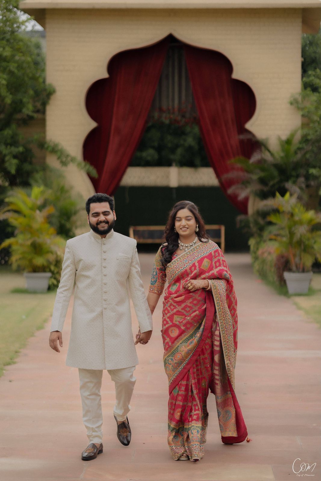 Satyam and Anshi walking together along a garden path
