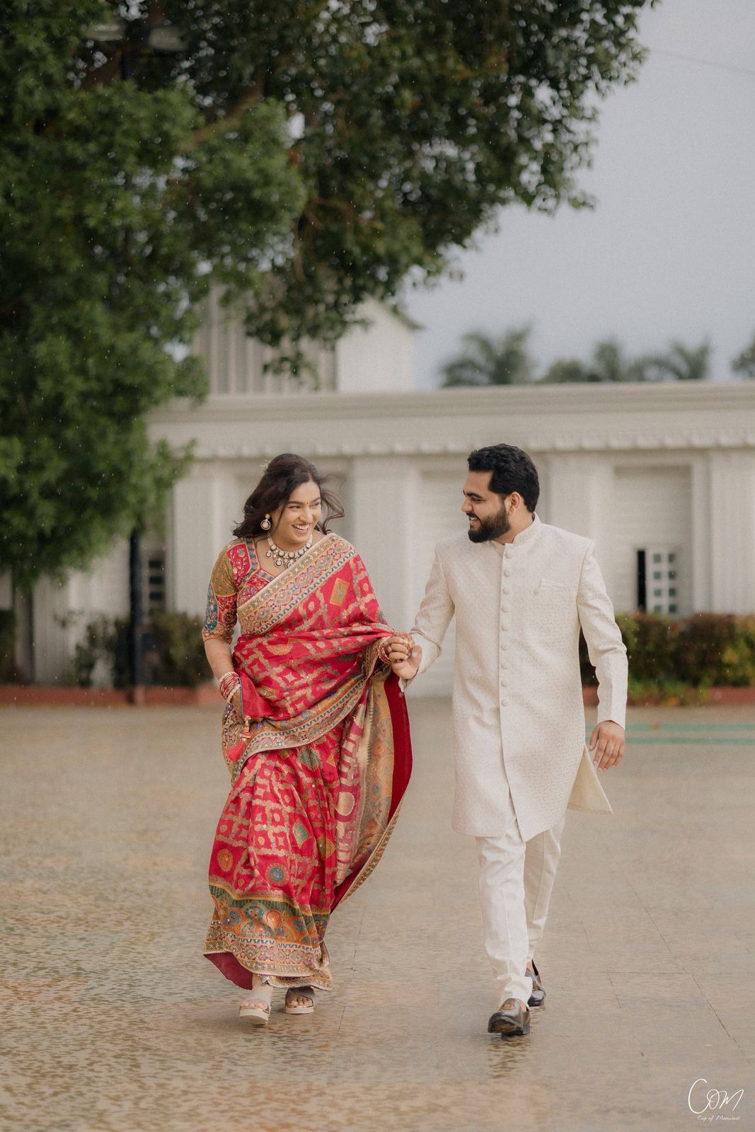 Anshi and Satyam laughing as they walk hand in hand